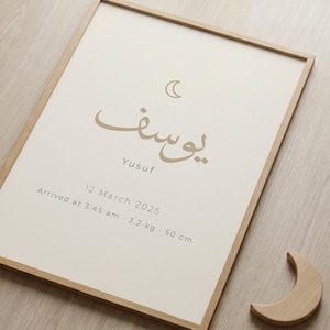 Peut inclure: Impression encadrée avec le prénom "Yusuf" en calligraphie arabe, un croissant de lune et les détails de naissance : 12 mars 2025, 3h45, 3,2 kg et 50 cm. Un croissant de lune en bois est à proximité. Le cadre est marron clair.