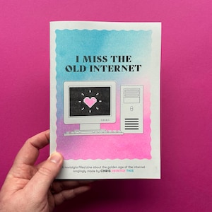 May include: A zine with the title "I Miss the Old Internet". The cover shows a retro computer graphic with a pixelated heart. The background has a blue and pink watercolor effect. The text reads "A nostalgia filled zine about the golden age of the internet".