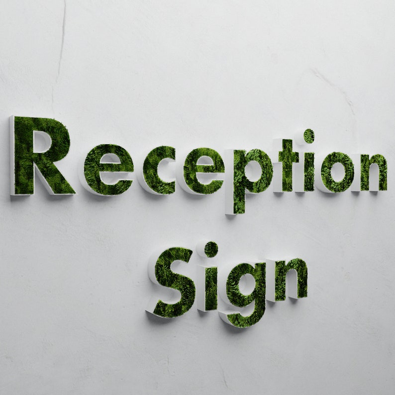 May include: White sign with the words "Reception Sign" in green letters made of moss.