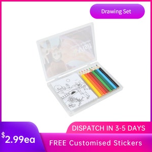 May include: A clear plastic case containing a drawing set. The case features a picture of a girl on the front. The drawing set includes a small pad of paper with a black and white drawing of a wolf and a girl, and a set of 8 coloured pencils. The text on the case reads "Drawing Set".