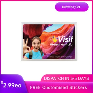 May include: A clear plastic case with a colourful image of a woman smiling and giving a thumbs up in front of a red and orange rock formation. The image also includes the text "Visit Western Australia" and "Deadmans Canyon, Kimberley Ranges".