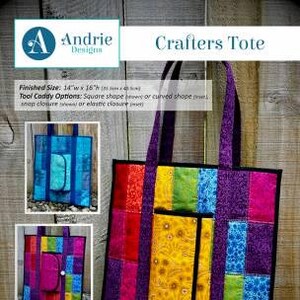 May include: A colorful tote bag with a smaller pocket on the front. The tote bag is made of patchwork fabric in shades of red, purple, green, yellow, and blue. The tote bag is 14 inches wide by 16 inches tall. The text "Crafters Tote" is printed in black at the top of the image.