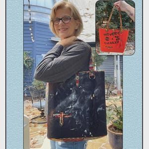 May include: A black quilted tote bag with white paint-like splatters, featuring patterned fabric trim, a black tassel, and metal hardware. An inset image shows a bright orange tote bag with the text MOVERS & SHAKERS and a black tassel.