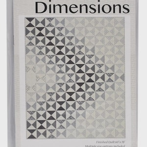May include: A quilt pattern titled Dimensions by Amy Ellis in a clear plastic sleeve. The cover features a geometric design of black, gray, and white triangles and patterned squares. The finished quilt measures 60 inches by 78 inches.