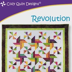 May include: A colorful quilt with a geometric pattern. The quilt features a white background with a repeating design of pinwheel-like shapes in shades of orange, yellow, green, purple, and pink. The quilt is bordered with green and brown fabric, and the text "Revolution" is displayed.