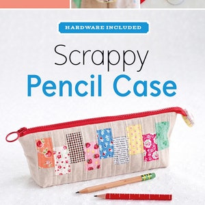 May include: A patchwork pencil case with a red zipper and a red zipper pull. The case is made of different fabrics with floral and geometric patterns. The text "Scrappy Pencil Case" is printed in blue and black on a white background. The text "Designed by Kristyne Czepuryk of Pretty by Hand" is printed in black on a white background.