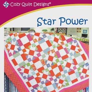 May include: A colorful quilt with a geometric pattern. The quilt features a white background with orange, pink, blue, and green squares and rectangles. The quilt is bordered with a pink fabric. The text "Star Power" is displayed.