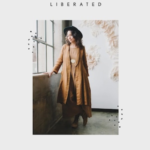 May include: A long, tan-colored duster coat with long sleeves and a wide collar, worn over a matching tan dress. The image includes the text SEW LIBERATED at the top and LICHEN DUSTER at the bottom, along with a graphic of a hand holding scissors.