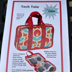 May include: A red and patterned Tech Tote bag with red handles. The bag is designed to carry chargers, batteries, flash drives, power cords, cameras, and mp3 players. The bag has four interior mesh pockets and is ideally sized for digital devices and accessories.