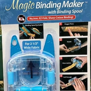 May include: A blue and clear plastic Magic Binding Maker with Binding Spool. The package includes instructions for use and states it is for 2 1/2" wide fabric. The product promises no-iron, EZ-fold, and sharp-crease binding.