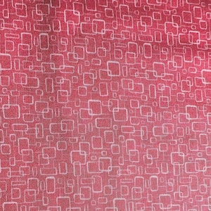 May include: Red fabric with a white geometric pattern of squares and rectangles.