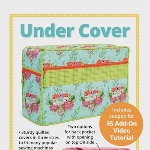 May include: A quilted sewing machine cover with a floral pattern in teal, green, and orange. The cover has a zippered top and a back pocket. Text on the cover reads "Under Cover". Includes a coupon for a video tutorial.