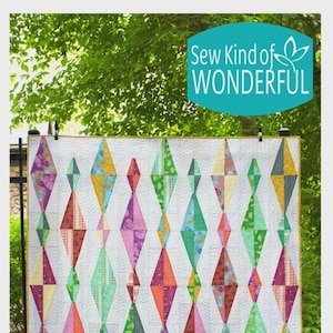 May include: A colorful quilt with a geometric diamond pattern. The diamonds are in various colors, including green, orange, pink, and yellow, set against a white background. The quilt has the text "Sew Kind of WONDERFUL" in a teal oval.