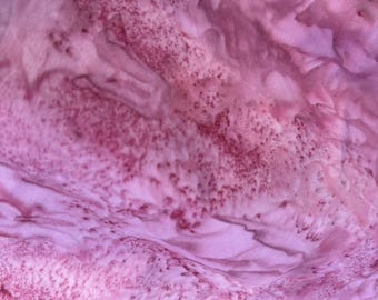 May include: Close-up of a pink fabric with a subtle, speckled pattern. The fabric has a soft, flowing texture and a light, airy feel.
