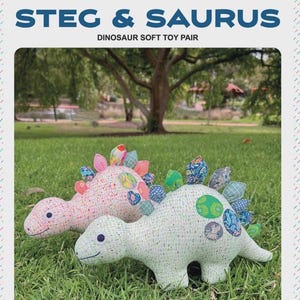 May include: Two soft dinosaur toys, one pink and one green, rest on green grass. The pink dinosaur has pink and colorful accents, while the green dinosaur has green and blue accents. The text "STEG & SAURUS DINOSAUR SOFT TOY PAIR" is at the top.