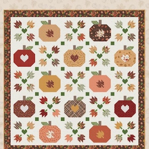 May include: A square quilt featuring a repeating pattern of pumpkins and autumn leaves in shades of red, orange, brown, and cream. The design includes heart-shaped cutouts on some pumpkins and a dark brown border with a floral leaf print.