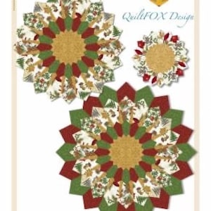 May include: Three circular fabric table toppers and placemats featuring a starburst pattern in red, green, and cream with pine tree and cone motifs. Text reads: QuiltFOX Design, Christmas Table Topper, diameter: 40" and 50", Placemat, diameter: 18 1/2".