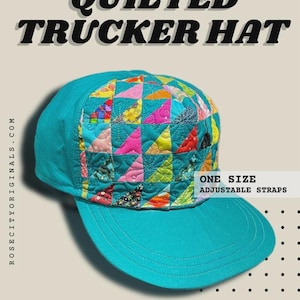 May include: A teal quilted trucker hat with a colorful patchwork design on the crown. The patchwork features various colors including pink, yellow, and red triangles. The hat has a curved brim and adjustable straps. Text on the hat reads "Quilted Trucker Hat".
