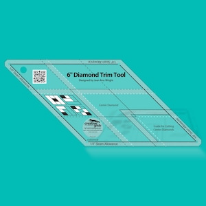 May include: A clear, diamond-shaped quilting tool with the text "6" Diamond Trim Tool" and "Designed by Jean Ann Wright." It features markings for seam allowance and cutting guides. The tool is designed for quilting and fabric crafts.