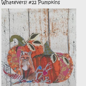 May include: A fabric art piece featuring two orange pumpkins with green leaves and a fox. The pumpkins have patterned sections in orange, pink, and yellow. The fox is brown and white. The text "Whatevers! #22 Pumpkins" is at the top.