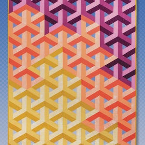 May include: A colorful quilt titled "Entangled Sky" with a geometric pattern in shades of yellow, orange, pink, and purple. The quilt measures 55" x 74". The designer's name, Krista Moser, and the name of the company, The Quilted Life, are also visible.