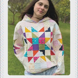 May include: A patchwork hoodie with a starburst design in the center, featuring various colorful fabric squares and triangles. The hoodie has a hood and is labeled "LEXI HOODIE" and "CASUAL PATCHWORK HOODED SWEATSHIRT". The brand logo "m&m MELLEY AND ME" is at the bottom.