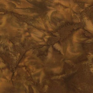 May include: A close-up of a fabric with a marbled appearance. The color palette consists of various shades of brown, from light tan to deep chocolate. The fabric has a textured, organic look, with swirling patterns.