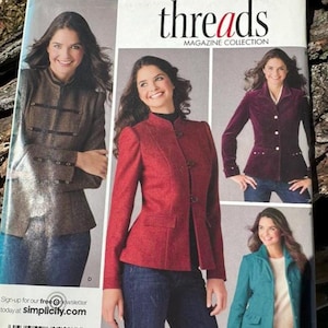 May include: Simplicity sewing pattern featuring jacket designs. The pattern includes images of jackets in various colors, including red, teal, and brown. The pattern's text includes the word "threads" and the phrase "Step by step to sewing success!"