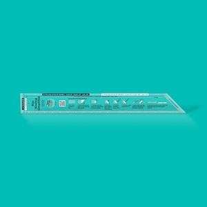 May include: A turquoise plastic ruler with the text "Bias Binding Simplified" and instructions for fabric binding. The ruler has a beveled edge and is designed for sewing projects. Measurements are in inches.