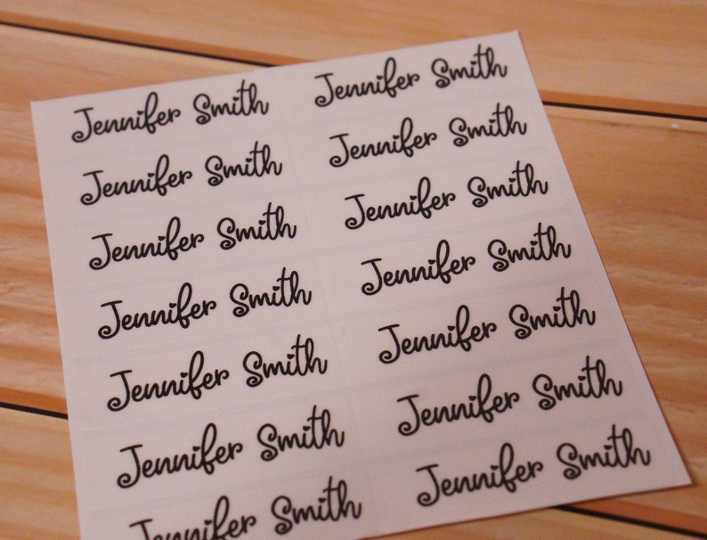 May include: A sheet of white labels with the name "Jennifer Smith" printed in a black, elegant script font. The labels are arranged in rows and columns, with each label clearly legible against the white background.