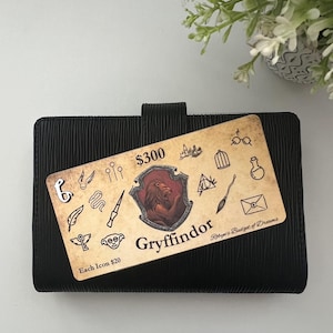 May include: A Gryffindor themed planner with a $300 price tag and a list of icons for $20 each. The planner has a black cover with a textured design. The Gryffindor crest is featured prominently on the planner.