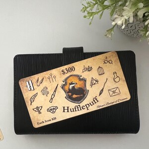 May include: A yellow and black Hufflepuff house crest with a badger on a black background. The crest is surrounded by various Harry Potter themed icons. The text "$300" and "Each Icon $20" is visible. The text "Robyn's Badge of Dreams" is also visible.