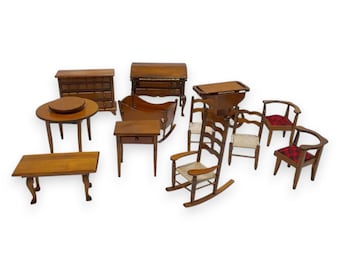 May include: A collection of miniature wooden furniture pieces, including tables, chairs, a dresser, and a rocking chair. The furniture is a warm brown color, with some chairs featuring red and black plaid fabric. The set is ideal for dollhouses or miniature displays.