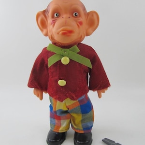 Old mechanical toy - dancing monkey with key in excellent condition