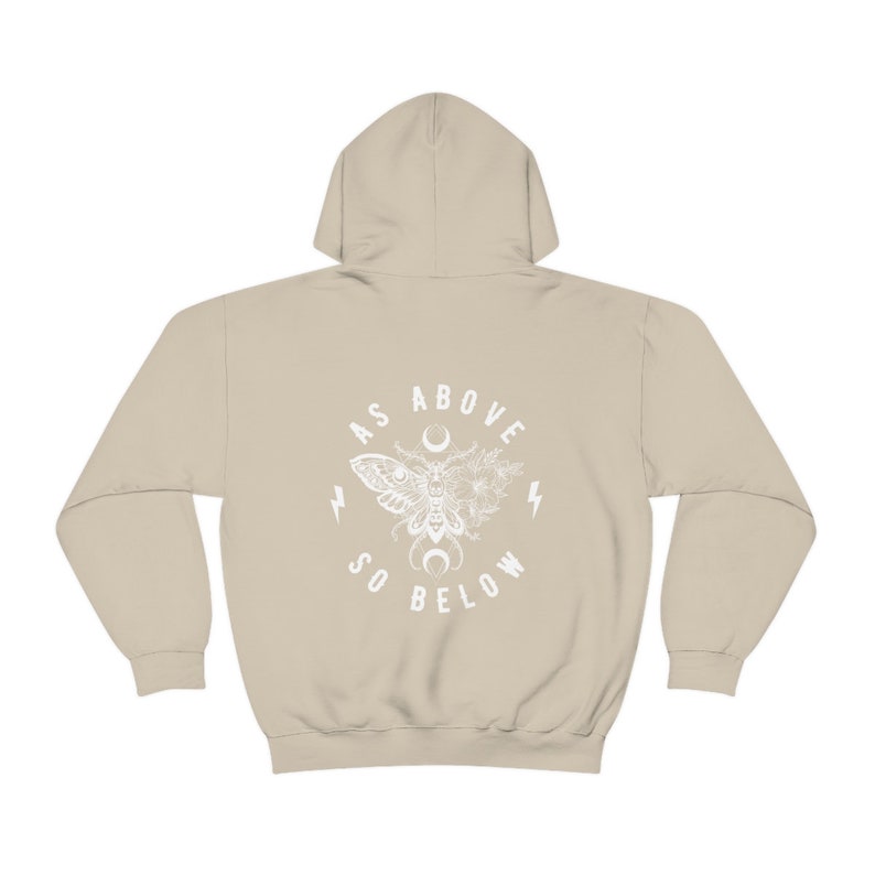May include: A beige hoodie with a white graphic print of a moth, flowers, and crescent moon. The text "As Above So Below" is printed in a circle around the graphic.