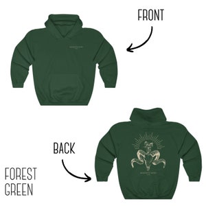 May include: Forest green hooded sweatshirt with a skull and horns graphic on the back. The text "Memento Mori 1921" is printed below the graphic.