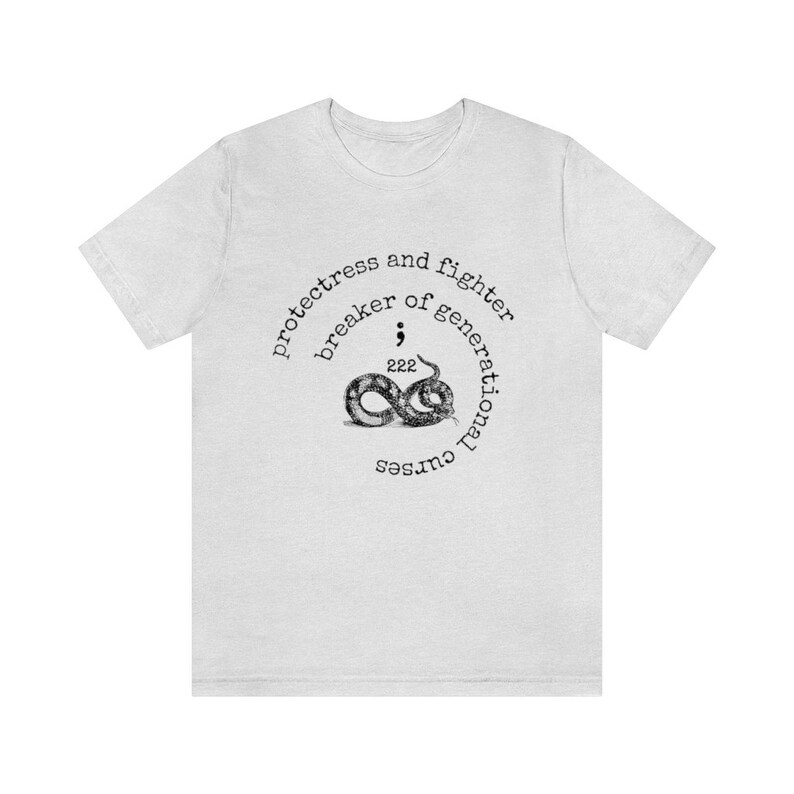 May include: White t-shirt with a black and white graphic of a snake with the text "protectress and fighter breaker of generational curses".