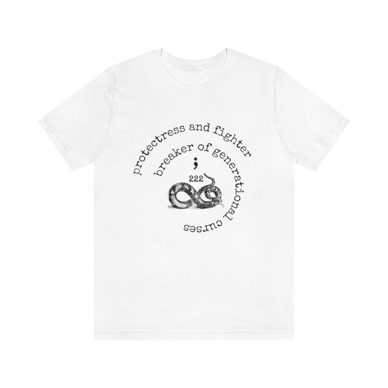 May include: White t-shirt featuring a black and white graphic design of a snake with the text "protectress and fighter breaker of generational curses; 222"