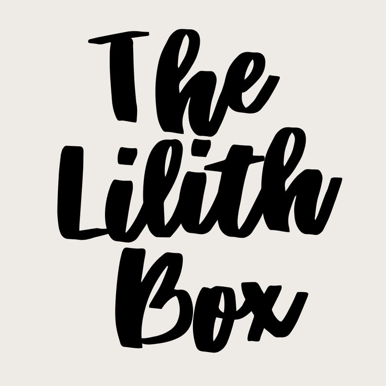 May include: The Lilith Box text in black script on a cream background. The text is in a bold, handwritten style, with the words stacked vertically. The background is a solid, neutral color.