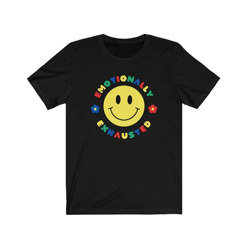 May include: Black t-shirt with a yellow smiley face and the text "Emotionally Exhausted" in a colorful circle.