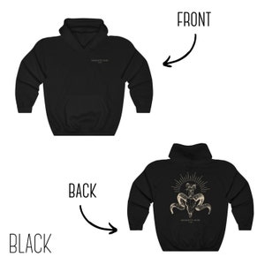 May include: Black hooded sweatshirt with a skull and crossbones graphic on the back. The graphic is in gold and features the text "Memento Mori" on the bottom. The front of the sweatshirt has the text "Memento Mori" in small print on the left chest.