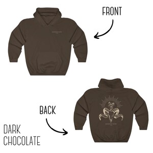 May include: A dark chocolate brown hoodie with a skull and horns design on the back. The design includes the text "Memento Mori 1993".