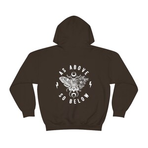 May include: A brown hooded sweatshirt with a white graphic print of a moth with wings spread, surrounded by flowers and the text "As Above So Below".