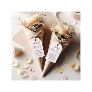 May include: Two small bouquets of white flowers in brown paper cones with white tags that say "Happy May Day" and a message about hoping the flowers bring smiles, joy, and a happy spring.
