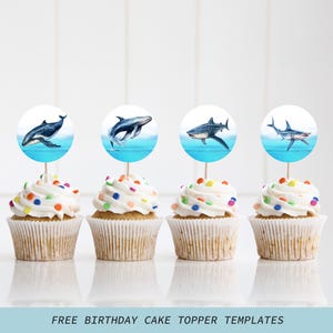 May include: Four cupcakes with white frosting and colorful sprinkles. Each cupcake has a round topper with a watercolor image of a whale or shark above blue water. The text "FREE BIRTHDAY CAKE TOPPER TEMPLATES" is at the bottom.