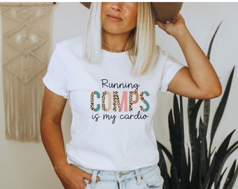 May include: White t-shirt with the text "Running COMPS is my cardio" in pink, blue, and brown letters with a leopard print pattern.