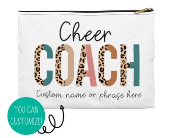 May include: White zippered pouch with the text "Cheer Coach" in black with leopard print accents. The text "Custom name or phrase here" is below the main text.