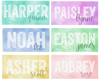 May include: Six colorful beach towels with names and middle names printed in white. The towels are in shades of green, blue, pink, yellow, and purple.