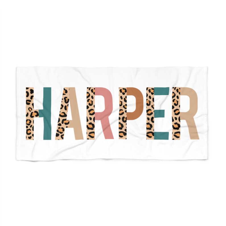 May include: White beach towel with the name "HARPER" printed in large, bold letters. Each letter is filled with a leopard print pattern and has a different colored background: teal, beige, pink, brown, teal, beige.