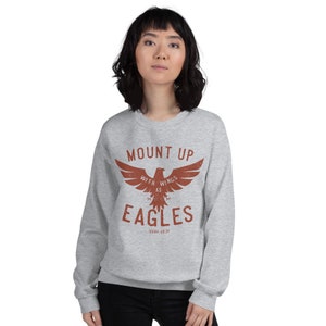May include: Gray sweatshirt with a red eagle graphic and the text "Mount Up With Wings As Eagles Isaiah 40:31".